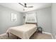 Bedroom with a queen bed, ceiling fan, and wood-look floors at 5732 W Purdue Ave, Glendale, AZ 85302