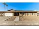 Single-story home with solar panels and a spacious front yard at 5732 W Purdue Ave, Glendale, AZ 85302