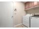 Laundry room with Whirlpool washer and dryer, and cabinets at 5732 W Purdue Ave, Glendale, AZ 85302