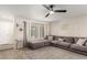 Cozy living room with L-shaped sectional sofa and wood-look floors at 5732 W Purdue Ave, Glendale, AZ 85302