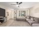 Bright living room with L-shaped sectional sofa and wood-look floors at 5732 W Purdue Ave, Glendale, AZ 85302