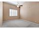 Bright bedroom with ceiling fan and large window with shutters at 6429 E Everett Dr, Scottsdale, AZ 85254