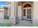 Arched entryway with a security door and neutral color scheme at 6429 E Everett Dr, Scottsdale, AZ 85254