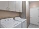 Laundry room with washer, dryer, and built-in cabinets at 6429 E Everett Dr, Scottsdale, AZ 85254