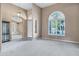 Bright living area with high ceilings, arched entryways, and a chandelier at 6429 E Everett Dr, Scottsdale, AZ 85254