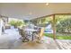 Inviting covered patio with dining set overlooking pool and lush landscaping for relaxing and entertaining at 701 W Cambridge Ave, Phoenix, AZ 85007