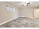 Neutral bedroom featuring tile flooring, a ceiling fan, and a sunlit window at 701 W Cambridge Ave, Phoenix, AZ 85007