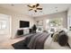 The primary bedroom showcases a ceiling fan, ample natural light, and a sleek entertainment center at 701 W Cambridge Ave, Phoenix, AZ 85007