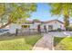 Charming single-story home featuring a red tile roof, well-kept lawn, and a quaint stone pathway leading to the front door at 701 W Cambridge Ave, Phoenix, AZ 85007