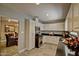 Well-lit kitchen features white cabinets, stainless steel appliances, and sleek black countertops at 701 W Cambridge Ave, Phoenix, AZ 85007