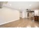 Spacious living room featuring hardwood floors, a ceiling fan, and easy access to the wet bar at 701 W Cambridge Ave, Phoenix, AZ 85007