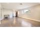 Spacious living room featuring hardwood floors, a large window for natural light, and neutral walls at 701 W Cambridge Ave, Phoenix, AZ 85007