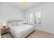 Bright bedroom with plush bed, window shutters, and wood floors at 7027 N Scottsdale Rd # 225, Paradise Valley, AZ 85253