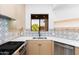 Modern kitchen with stainless steel appliances and unique backsplash at 7027 N Scottsdale Rd # 225, Paradise Valley, AZ 85253