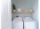 Laundry room with washer, dryer, and overhead shelving at 7027 N Scottsdale Rd # 225, Paradise Valley, AZ 85253