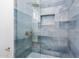 Updated shower with blue tile and glass enclosure at 7027 N Scottsdale Rd # 225, Paradise Valley, AZ 85253