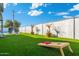 Artificial turf backyard with cornhole and pool view at 7837 N 13Th St, Phoenix, AZ 85020