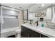 Modern bathroom with a gray tile shower, quartz countertop, and stylish vanity at 7837 N 13Th St, Phoenix, AZ 85020