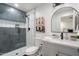 Modern bathroom with a walk-in shower, gray tile, and updated vanity at 7837 N 13Th St, Phoenix, AZ 85020