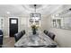 Elegant dining room featuring a large marble table and modern chandelier at 7837 N 13Th St, Phoenix, AZ 85020