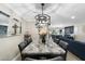 Elegant dining room with a large granite table and modern chandelier at 7837 N 13Th St, Phoenix, AZ 85020