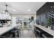 Modern kitchen with breakfast bar, black geometric backsplash, and access to patio at 7837 N 13Th St, Phoenix, AZ 85020