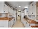 Clean kitchen featuring wood countertops and white cabinets at 8103 E Southern Ave # 39, Mesa, AZ 85209