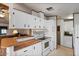 White kitchen with wood countertops and ample cabinet space at 8103 E Southern Ave # 39, Mesa, AZ 85209