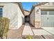 Front entry with walkway, stone accents, and gray door at 8513 N 172Nd Ln, Waddell, AZ 85355