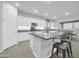 Modern kitchen with island, granite countertops, and white cabinets at 8513 N 172Nd Ln, Waddell, AZ 85355