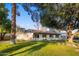 Single-story home with a red tile roof, landscaping, and a large tree in the front yard at 8614 E Appaloosa Trl, Scottsdale, AZ 85258