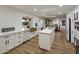 Spacious kitchen features white cabinetry, an island, and open dining area at 8614 E Appaloosa Trl, Scottsdale, AZ 85258