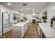 White kitchen with center island, stainless steel appliances, and quartz countertops at 8614 E Appaloosa Trl, Scottsdale, AZ 85258