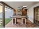 Gorgeous outdoor kitchen with a built-in grill and terracotta tile flooring at 8614 E Appaloosa Trl, Scottsdale, AZ 85258