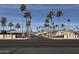 Holiday Palms community entrance with palm trees and signage at 9302 E Broadway Rd # 24, Mesa, AZ 85208