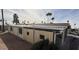 Tan mobile home with covered patio and desert landscaping at 9302 E Broadway Rd # 24, Mesa, AZ 85208