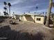 Tan single wide mobile home with covered patio and desert landscaping at 9302 E Broadway Rd # 24, Mesa, AZ 85208