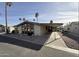 Tan single-wide manufactured home with carport and desert landscaping at 9302 E Broadway Rd # 24, Mesa, AZ 85208