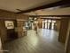 Open living area with wood-look floors, exposed beams, and large windows at 9302 E Broadway Rd # 24, Mesa, AZ 85208