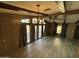 Bright living room with wood-look floors, exposed beams, and large windows at 9302 E Broadway Rd # 24, Mesa, AZ 85208