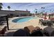 Community pool with lounge chairs and patio tables at 9302 E Broadway Rd # 24, Mesa, AZ 85208