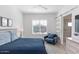 Main bedroom with a blue bedspread, barn door, and en-suite bathroom at 10359 E Morning Star Dr, Scottsdale, AZ 85255