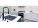 Modern kitchen detail showcasing a farmhouse sink and black faucet at 10359 E Morning Star Dr, Scottsdale, AZ 85255