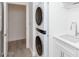 Laundry room with stacked washer and dryer and a quartz countertop at 10359 E Morning Star Dr, Scottsdale, AZ 85255