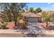 Single-story home with a tile roof, landscaped yard, and a two-car garage at 10387 W Runion Dr, Peoria, AZ 85382