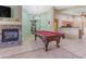 Game room with a pool table, fireplace, and an open concept design at 10387 W Runion Dr, Peoria, AZ 85382