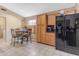 Kitchen boasting ample cabinet space, a breakfast nook, and a black refrigerator at 10387 W Runion Dr, Peoria, AZ 85382