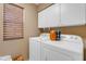 Bright laundry room, washer, dryer, and cabinets at 10387 W Runion Dr, Peoria, AZ 85382