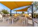 Outdoor kitchen and dining area with shade sails at 10712 E Trillium Ave, Mesa, AZ 85212