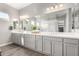 Double vanity bathroom with large mirror and ample counter space at 10712 E Trillium Ave, Mesa, AZ 85212